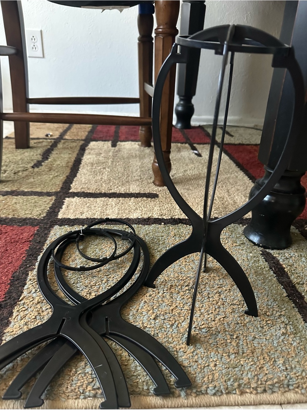Black plastic wig stands (3ct) and hair grip.